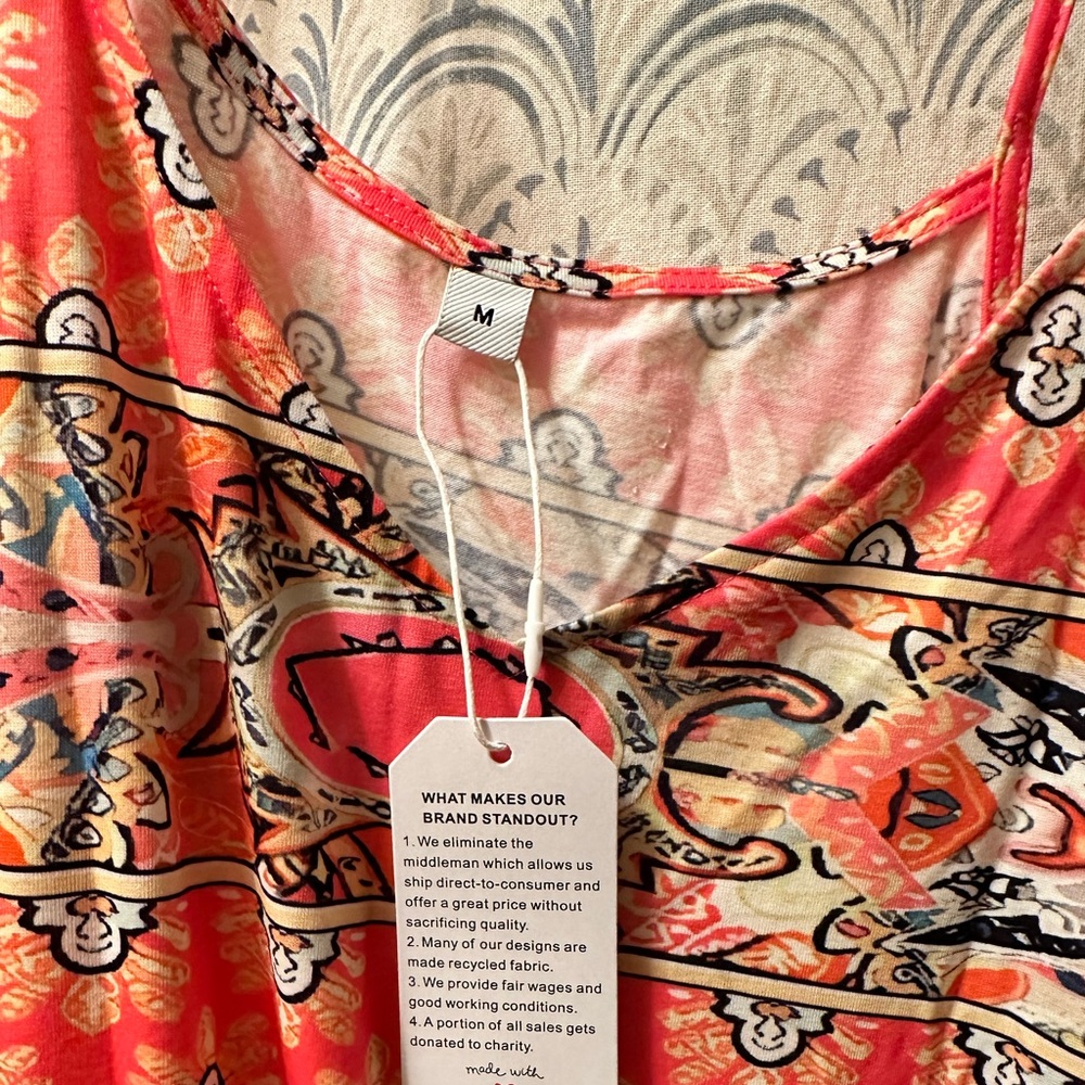 Women’s Dress orange colored with tie straps. Brand new. Size medium